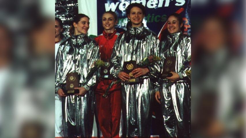 Utah women's gymnasts in 2001 with metallic-like jumpsuits after a meet.