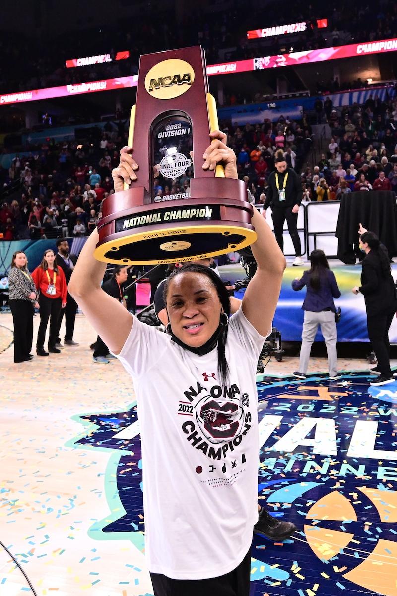 Gamecocks coach lifts trophy around the court